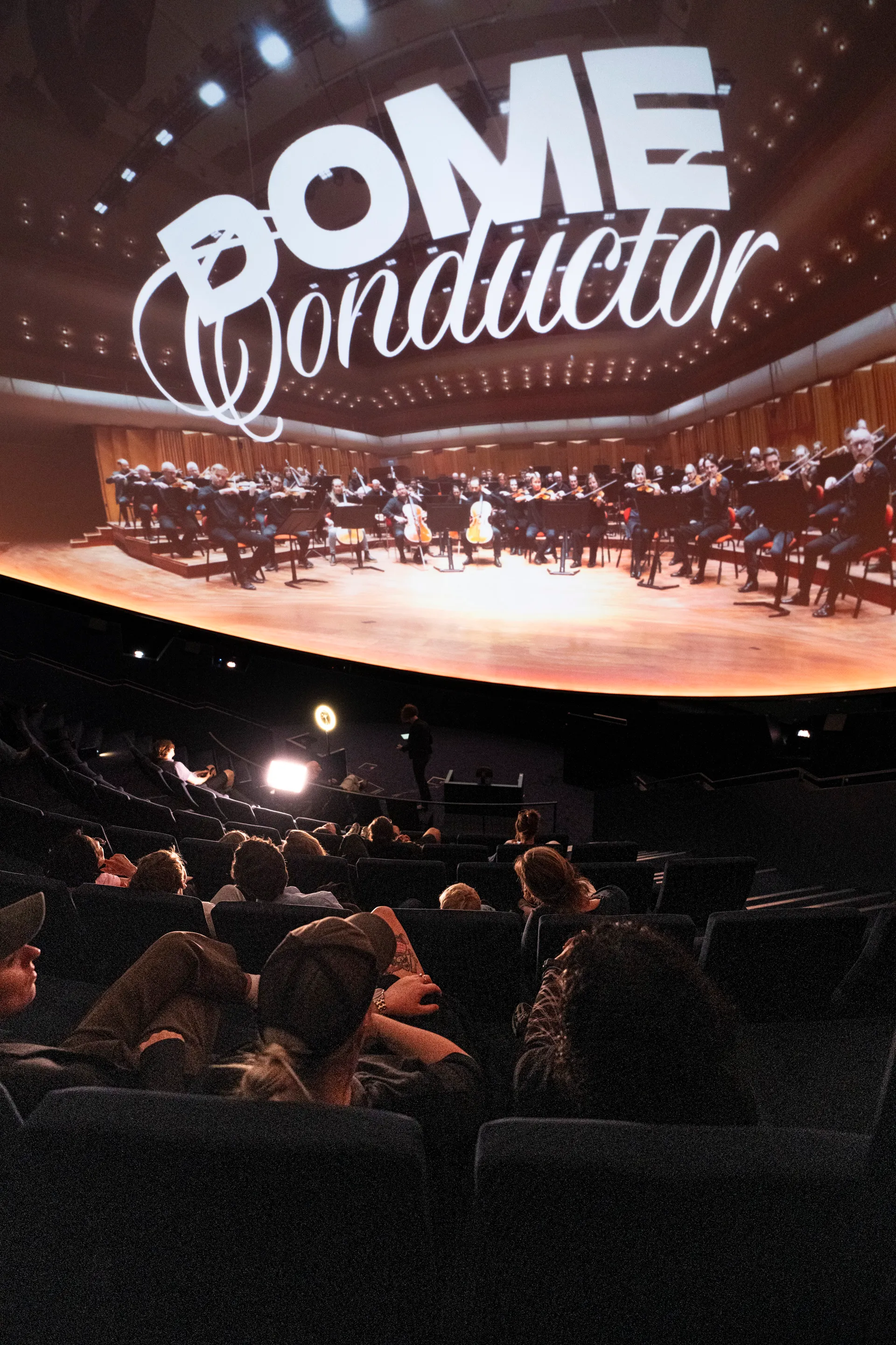 The Dome Conductor title projected across the fulldome with audience