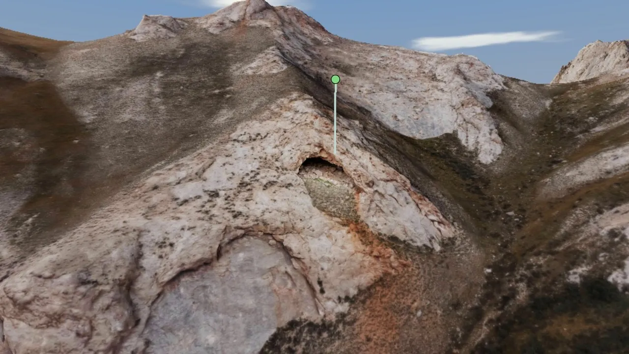 A cave mouth on the scanned slopes of Kok-Kiya, marked with a pin