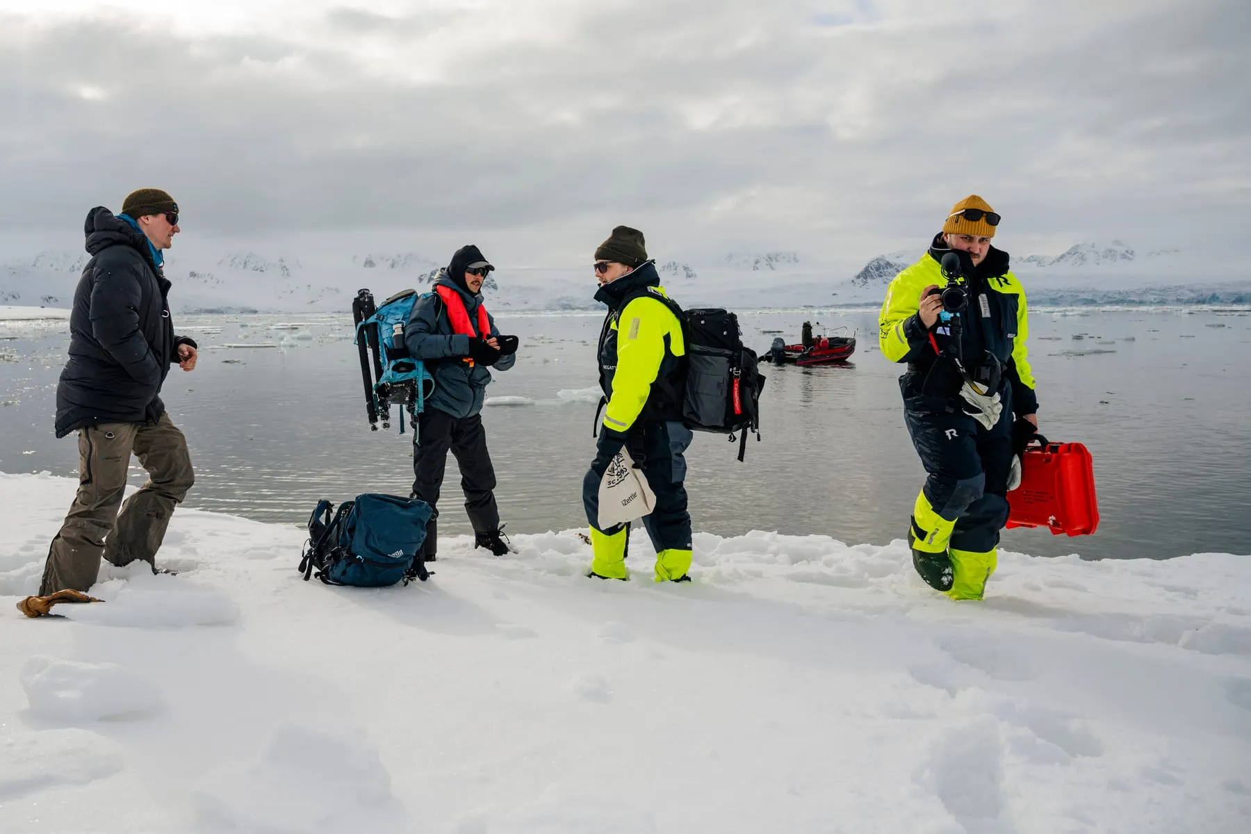The IVAR Studios crew with camera cases and tripods on sea ice in Svalbard